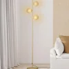 Lampadaire sur pied en métal doré avec 3 abat-jours globe verre